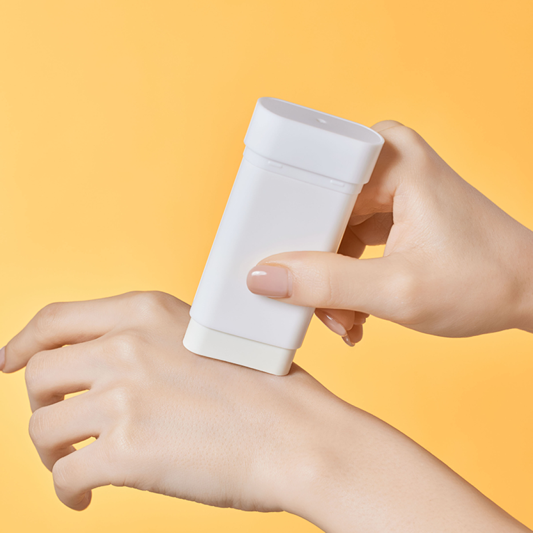 Applying ILLIYOON Daily Weaponless Sun Stick 20g on hand with a smooth glide for effective sun protection.