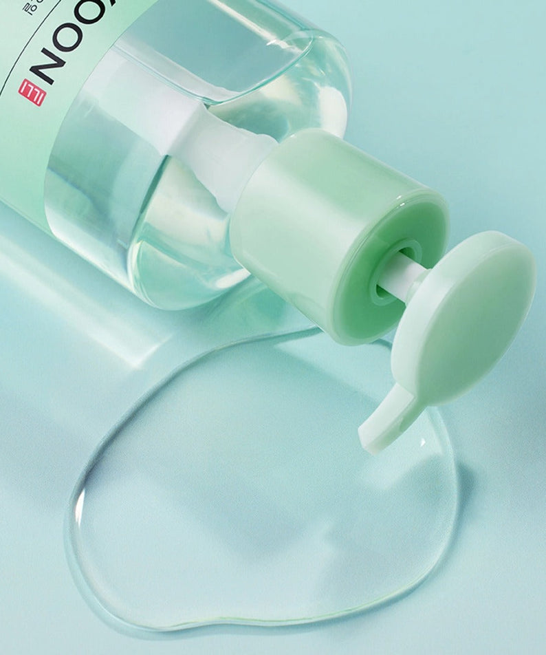 Bottle of ILLIYOON Gentle Deep Cleansing Oil 250ml with oil spill on a blue background