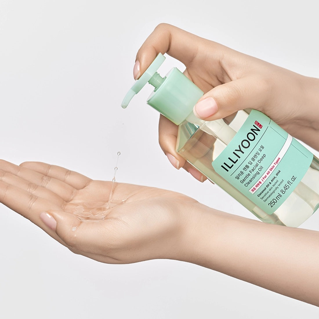 Hands using ILLIYOON Gentle Deep Cleansing Oil 250ml with pump dispenser for skincare routine