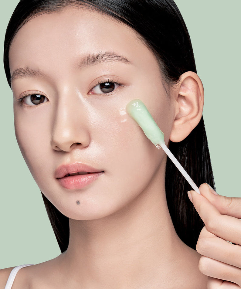 Woman applying ILSO No Trouble Peeling Swab 8 sheets on face for skincare routine