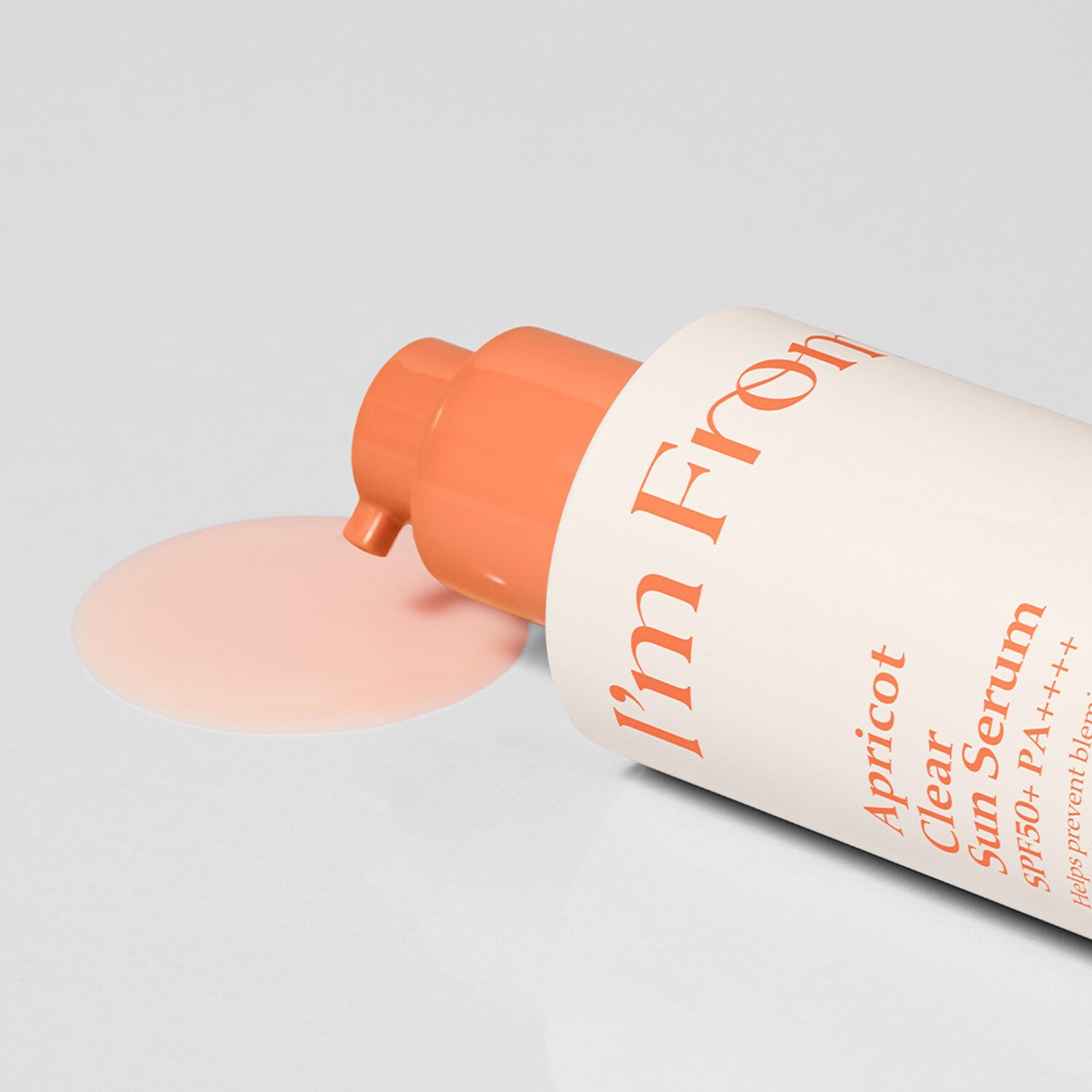 I'M FROM Apricot Clear Sun Serum 50ml bottle with open cap and spilled serum on a white surface