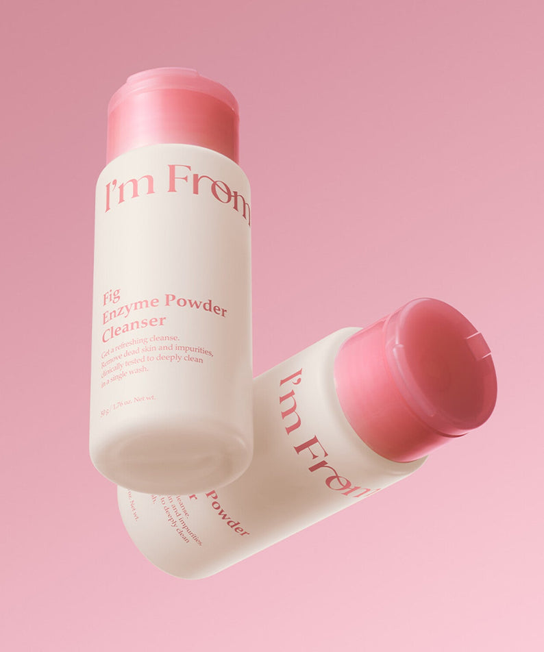 I'M FROM Fig Enzyme Powder Cleanser 50g on a pink background, featuring two bottles, enhancing skin clarity with natural fig enzymes.