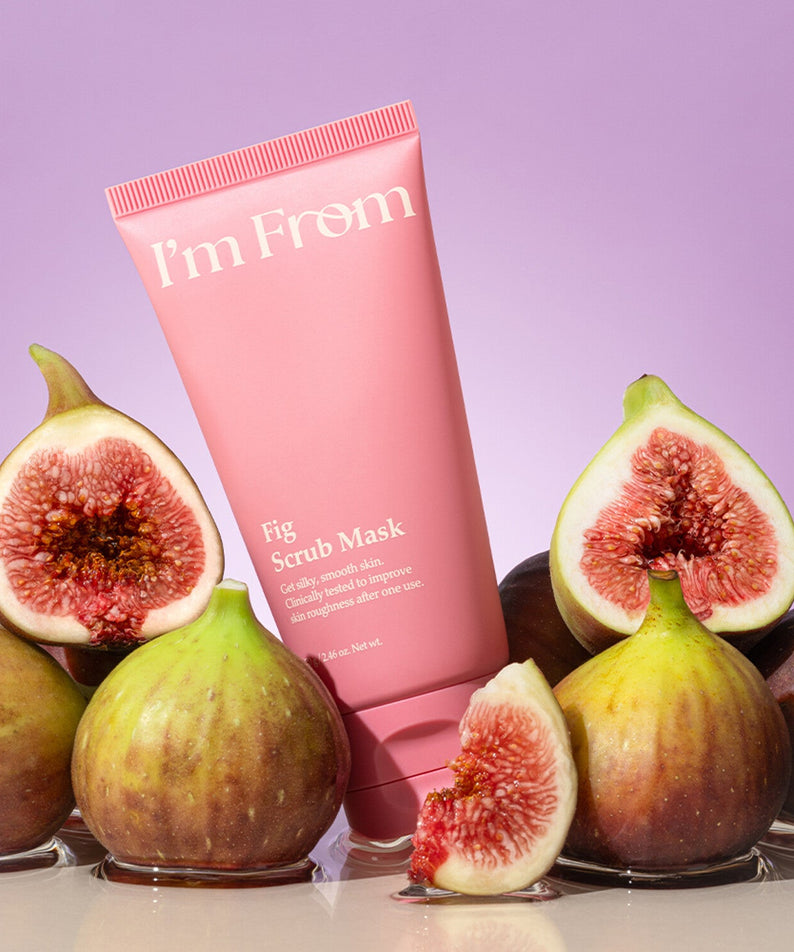 I'M FROM Fig Scrub Mask surrounded by fresh figs against a purple background, showcasing the product's natural ingredients.