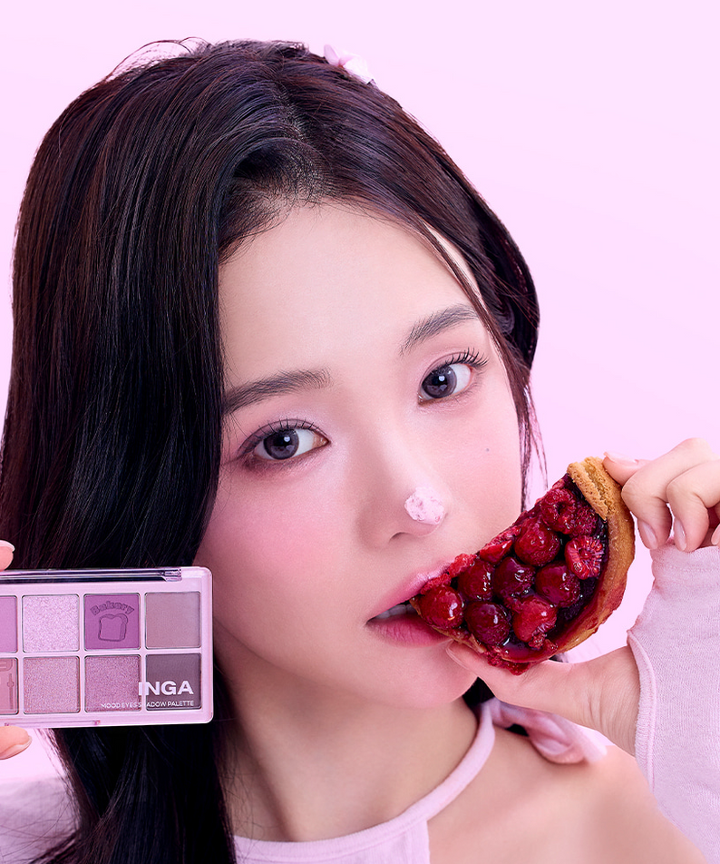 Woman holding INGA Mood Eyes Shadow Palette and berry tart against pink background