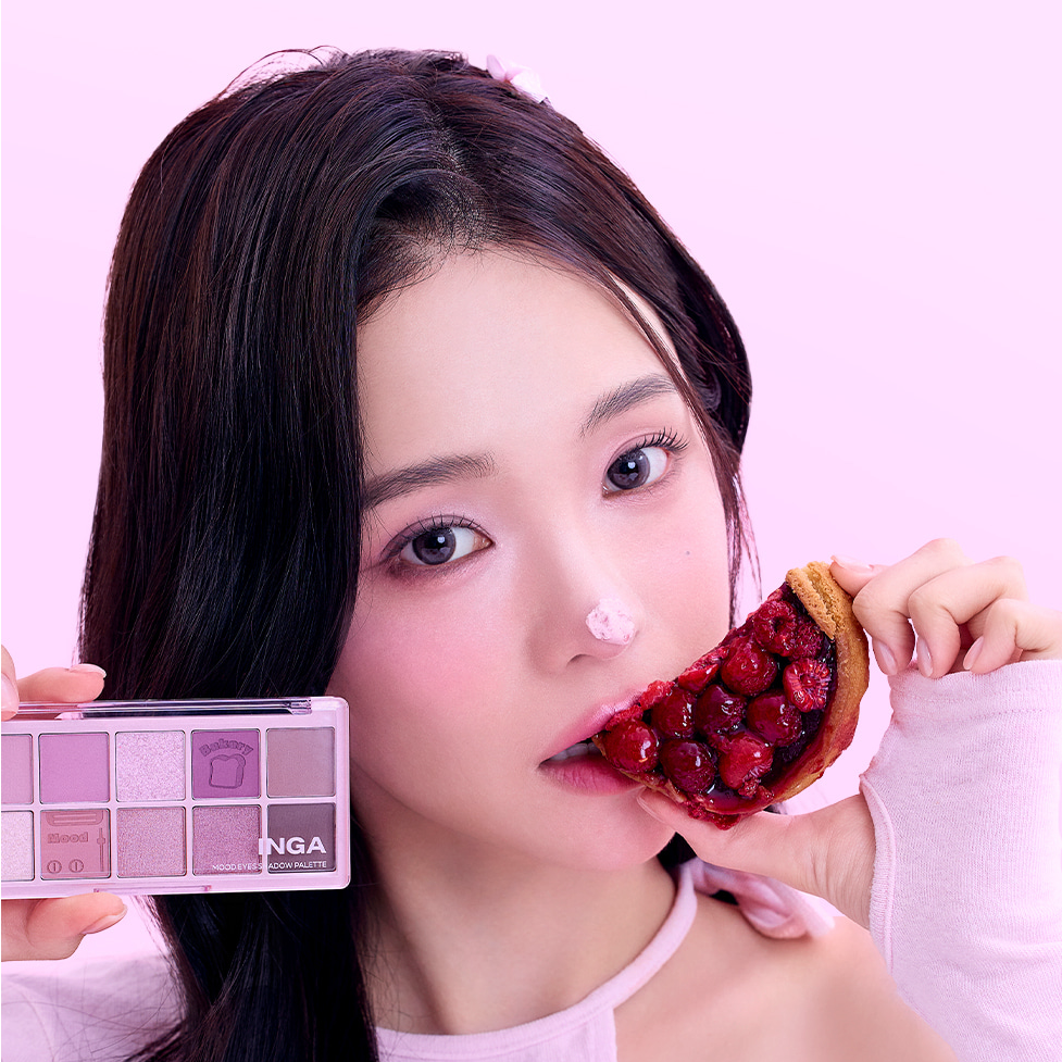 Woman holding INGA Mood Eyes Shadow Palette and berry tart against pink background