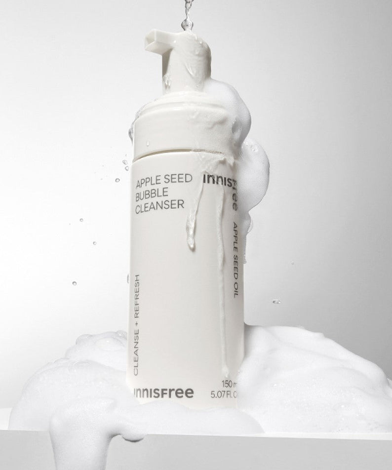INNISFREE Apple Seed Bubble Cleanser 150ml foaming bottle with lather on a white background.