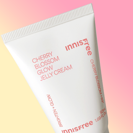 Close-up of INNISFREE Cherry Blossom Glow Jelly Cream 50ml with colorful background.