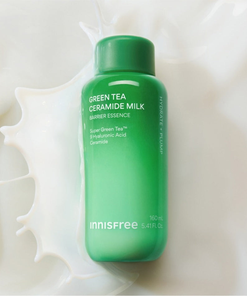 INNISFREE Green Tea Ceramide Milk Essence 160ml bottle on a milk splash background