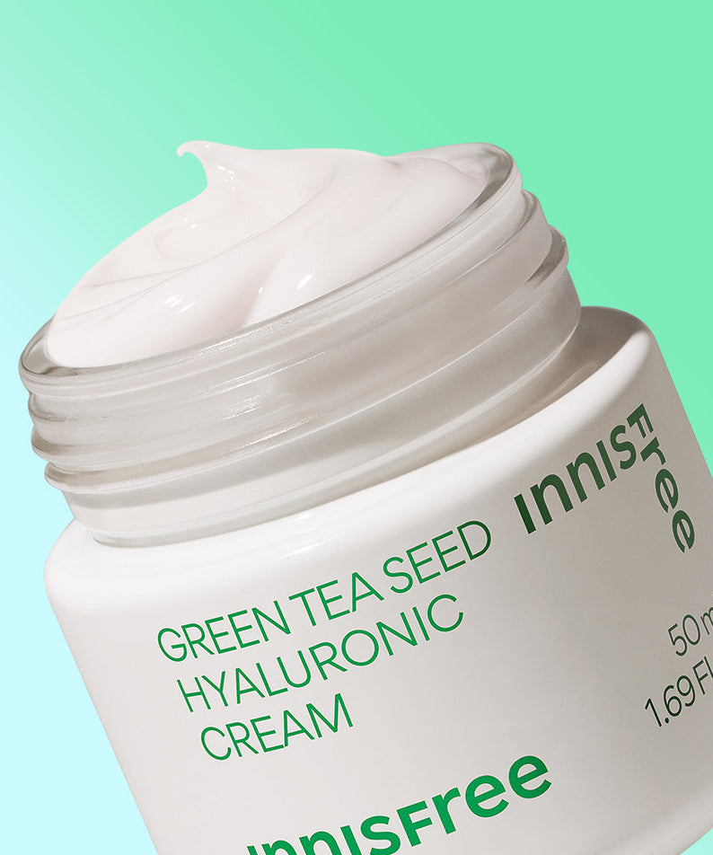Open jar of INNISFREE Green Tea Seed Hyaluronic Cream 50ml with product label visible.