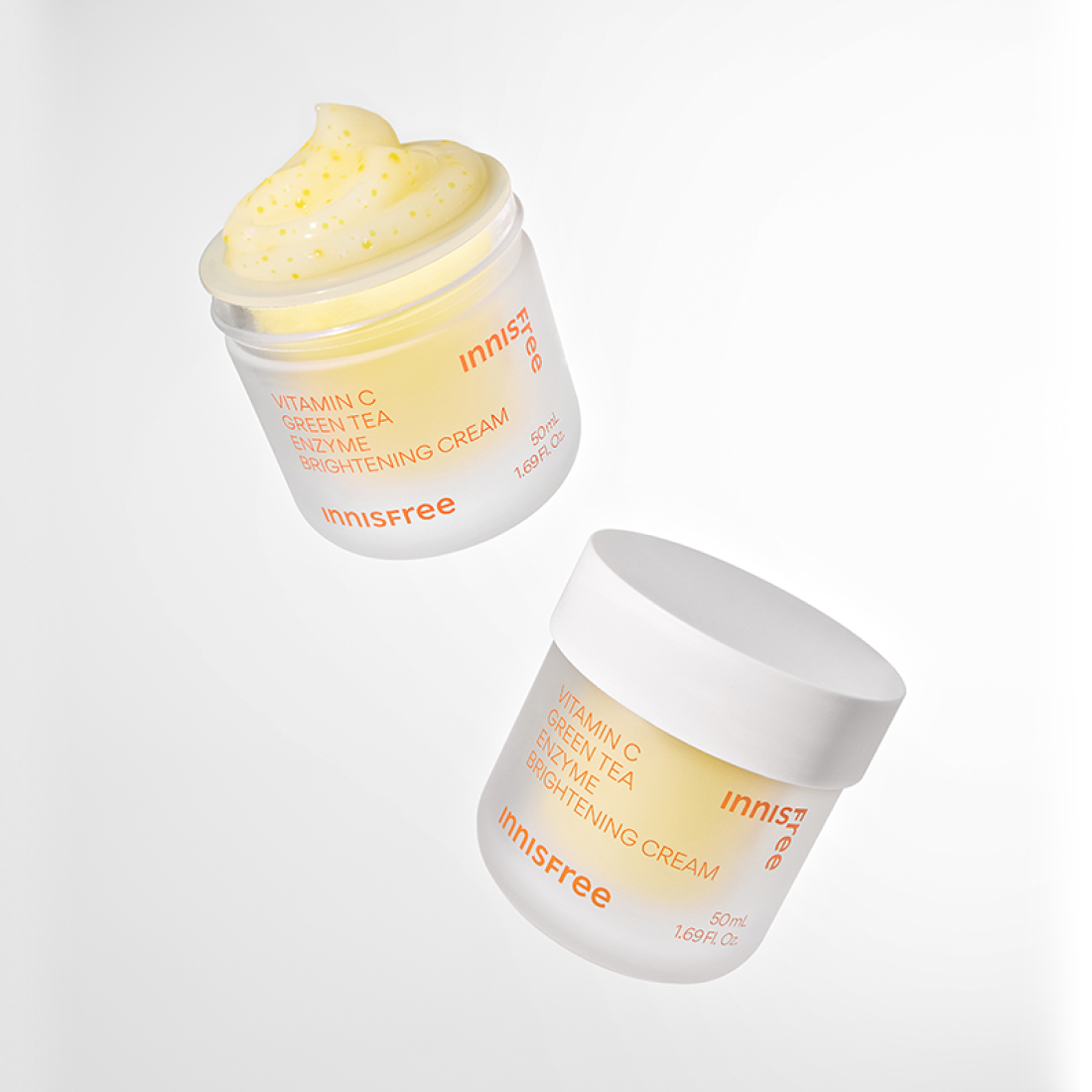 INNISFREE Vitamin C Enzyme Brightening Cream 50ml product image with jars and cream texture on a white background.