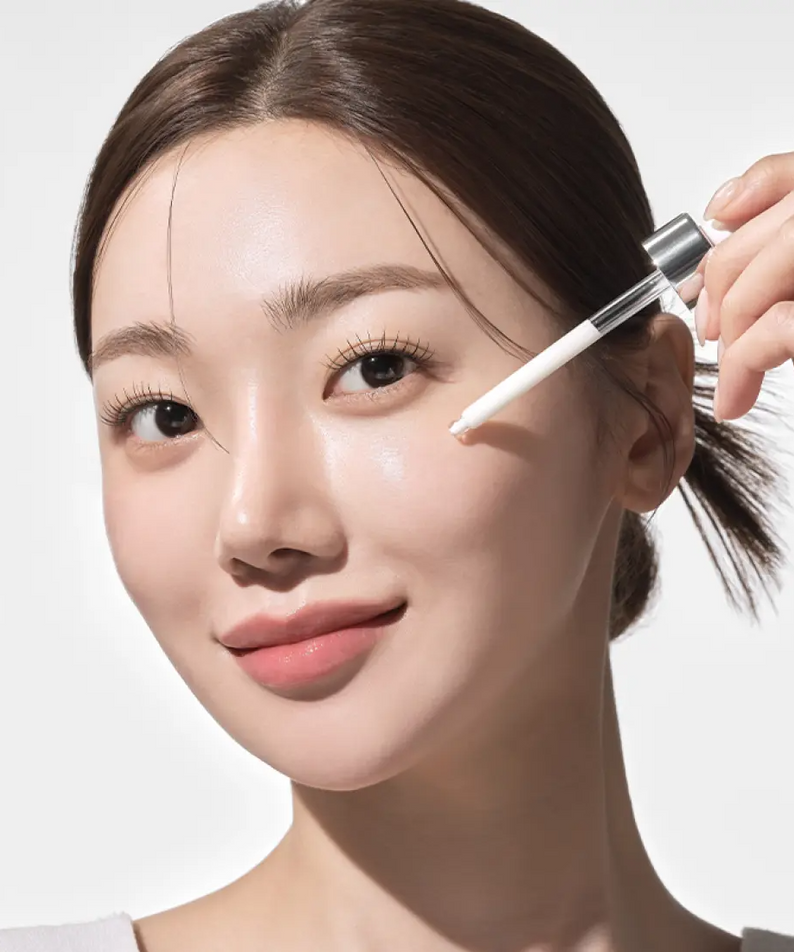 Woman applying IOPE UV Sheild Sun Ampoule SPF 50+PA+++ 40ml to her cheek for sun protection and skincare