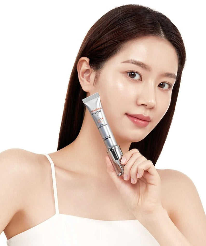 IOPE Vitamin C Expert 40% Mask Concentrate 15g held by woman