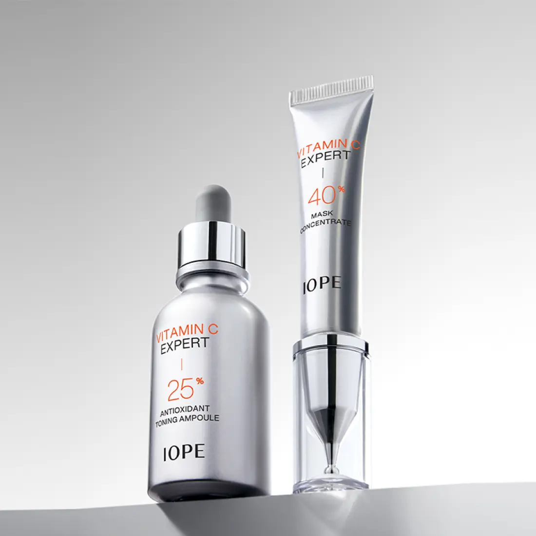 IOPE Vitamin C Expert 40% Mask Concentrate 15g shown with a 25% antioxidant toning ampoule bottle on gray background