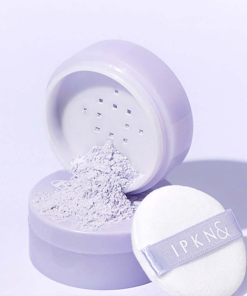 IPKN Personal Tone Correcting Powder (Lavender) with puff in open lavender packaging, perfect for color correction and smooth finish.