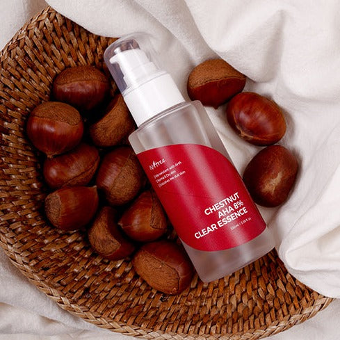 ISNTREE Chestnut AHA 8% Clear Essence 100ml bottle surrounded by chestnuts in a wicker basket