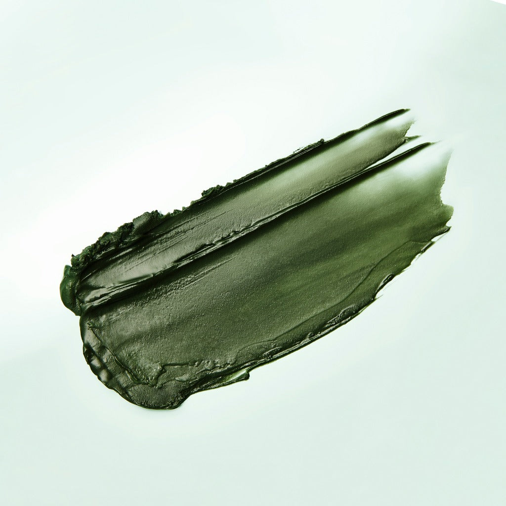 Texture of ISNTREE Mugwort Calming Deep Cleansing Balm 100g in a green smear on a light background.