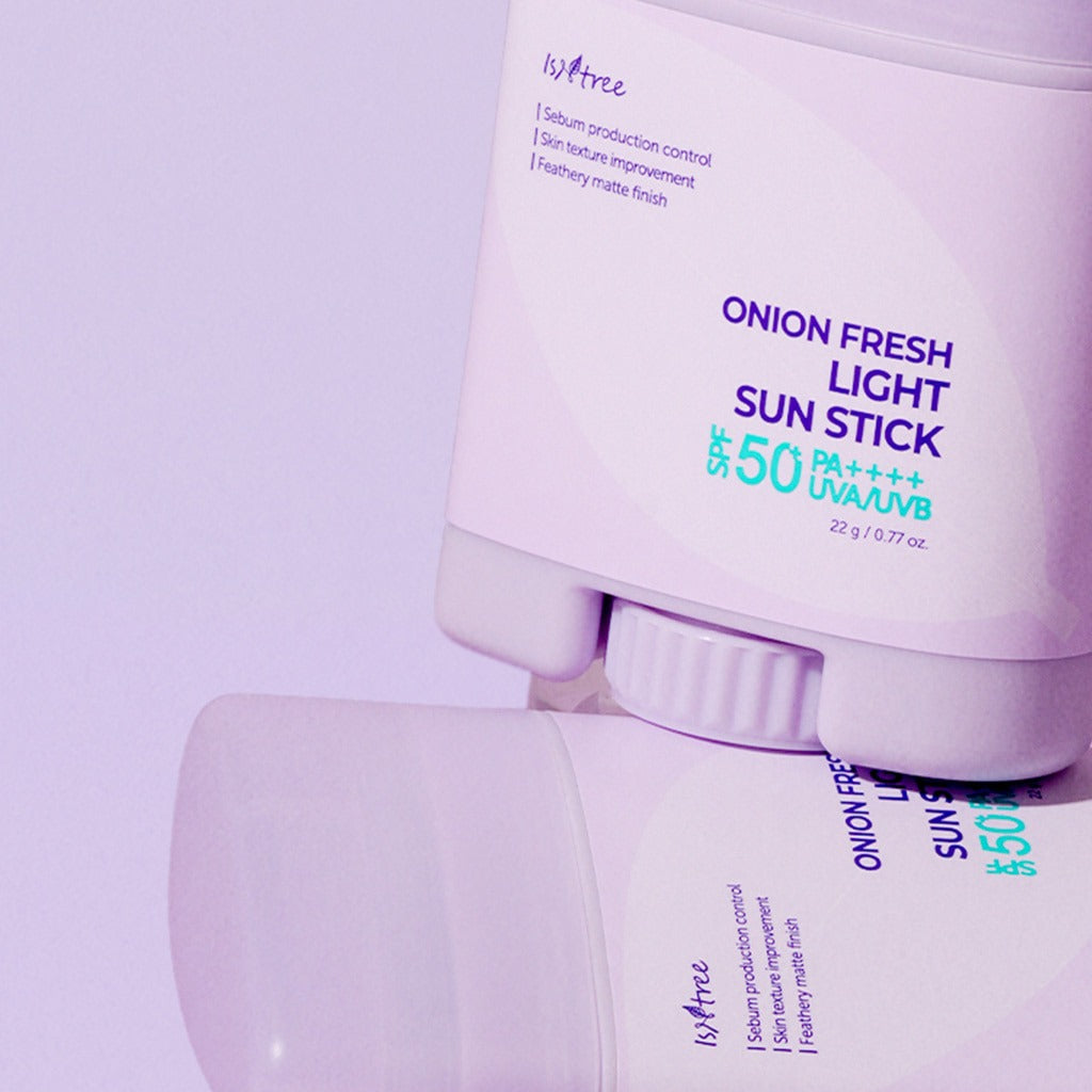 ISNTREE Onion Fresh Light Sun Stick 22g with SPF 50 displayed on a purple background.