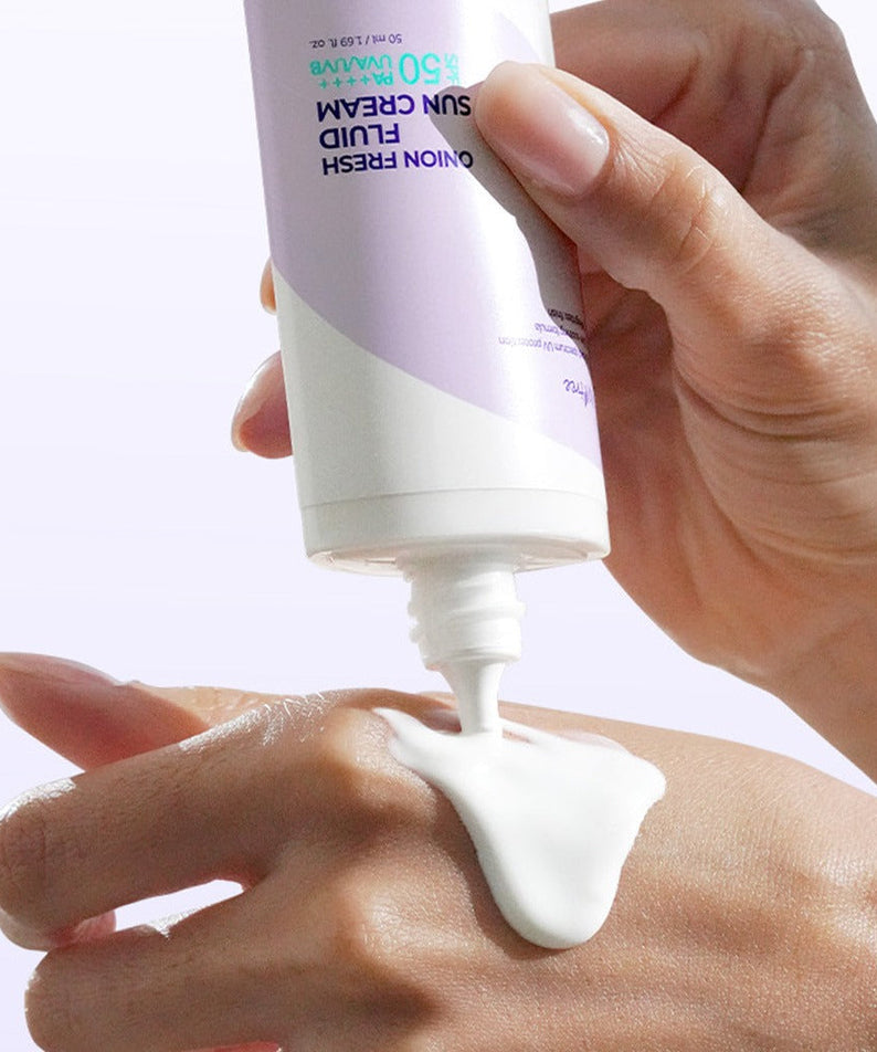ISNTREE Onion fresh Fluid Sun Cream 50ml being applied to hand for sun protection