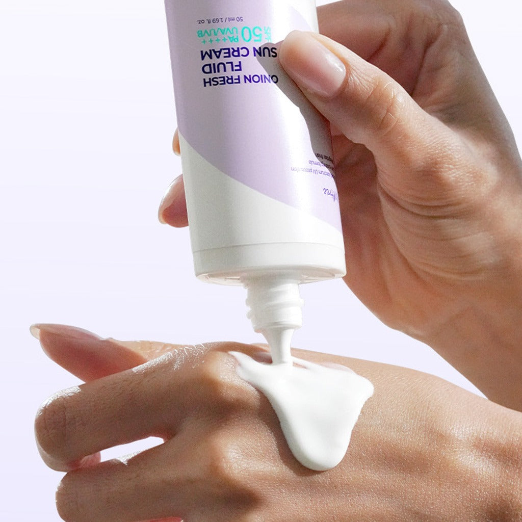 ISNTREE Onion fresh Fluid Sun Cream 50ml being applied to hand for sun protection