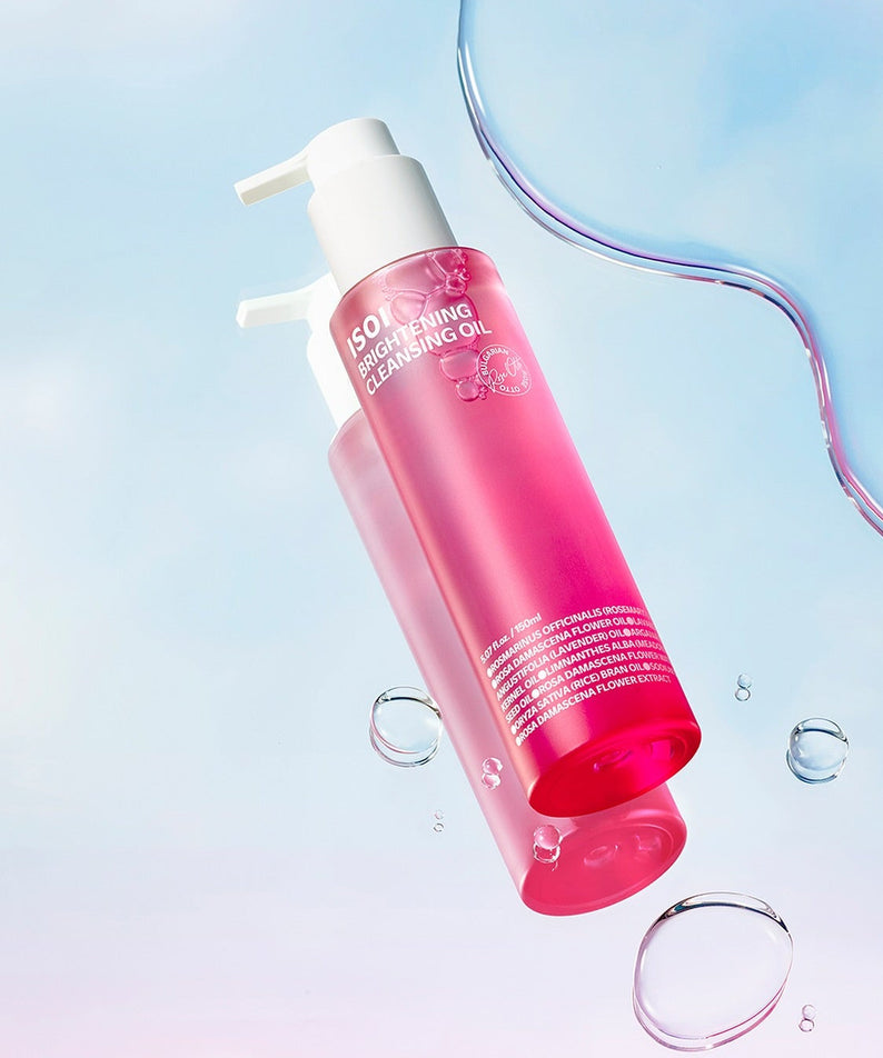 ISOI Brightening Cleansing Oil 150ml bottle with pink liquid, displayed with water droplets on a light blue background for skincare.