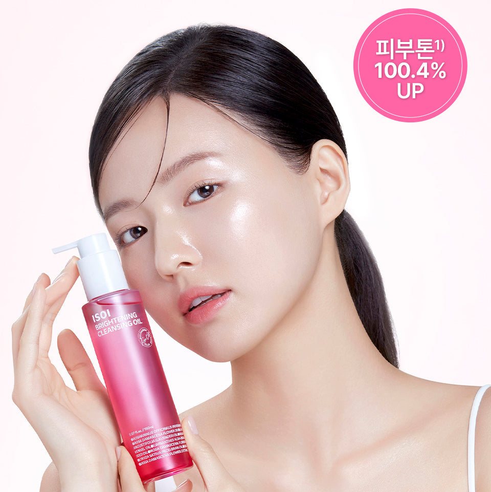 Woman holding ISOI Brightening Cleansing Oil 150ml with glowing skin for enhanced skincare routine