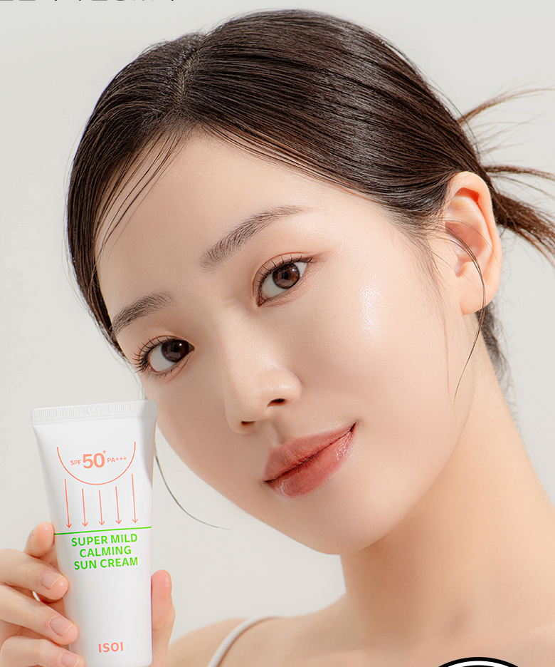 Woman holding ISOI Super Mild Calming Sun Cream SPF50+PA++++ 55ml, displaying skincare product.
