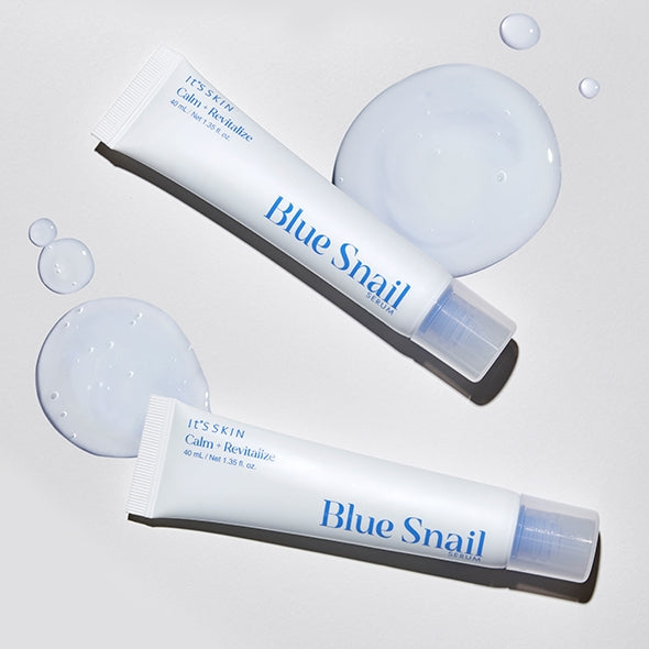 IT'S SKIN Blue Snail Serum 40ml displayed with drops of serum, offering skin revitalization and hydration for a glowing complexion.