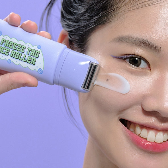 Woman using IT'S SKIN Freeze Tag Ice Roller on face, close-up view