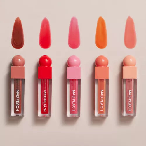 Assorted shades of IVI MAD PEACH Glow Fit Mood Gloss displayed with swatches, showcasing vibrant colors for beauty lovers.