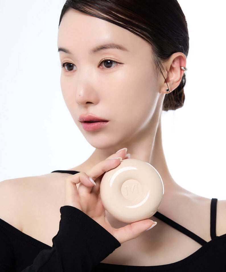 Person holding IVI MAD PEACH Plain Velvet Matte Cushion, showcasing its matte finish and design.