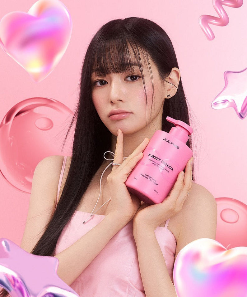 Woman holding JULYME Damage Care Perfume Hair Treatment 500ml with pink hearts and stars background