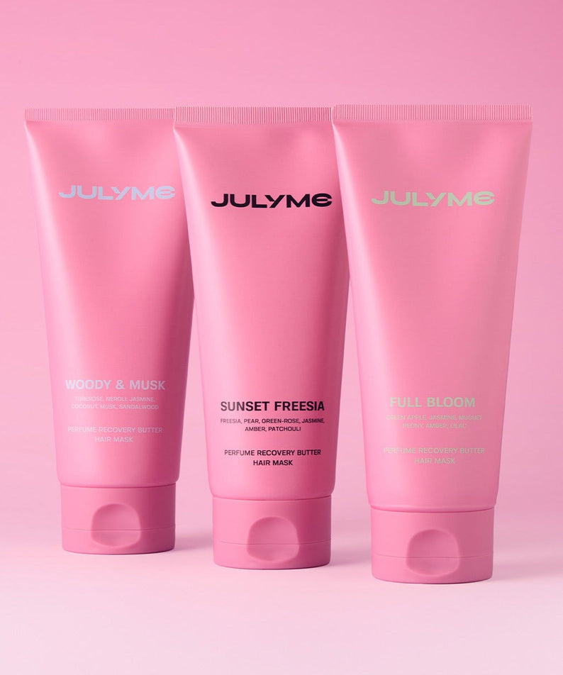 JULYME Perfume No-Wash Repair Hair Pack 150ml elegant pink tubes with various scents on a pink background.