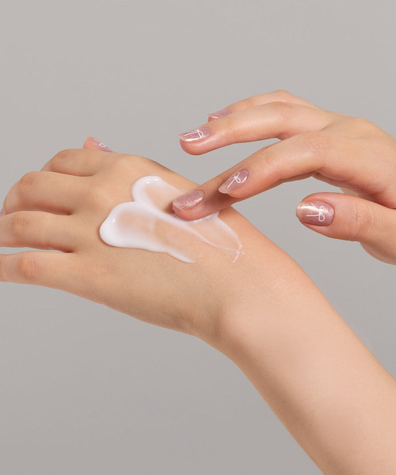Applying JULYME Perfume Shea Butter Hand Cream 30ml on hands for soft skin