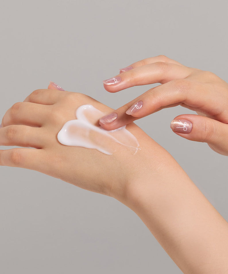 Applying JULYME Perfume Shea Butter Hand Cream 30ml on hands for moisturizing