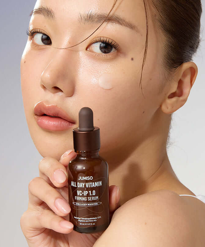 Woman holding JUMISO All Day Vitamin VC-IP 1.0 Elasticity Serum bottle close-up