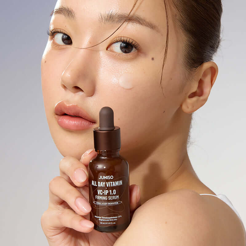 Woman holding JUMISO All Day Vitamin VC-IP 1.0 Elasticity Serum bottle close-up