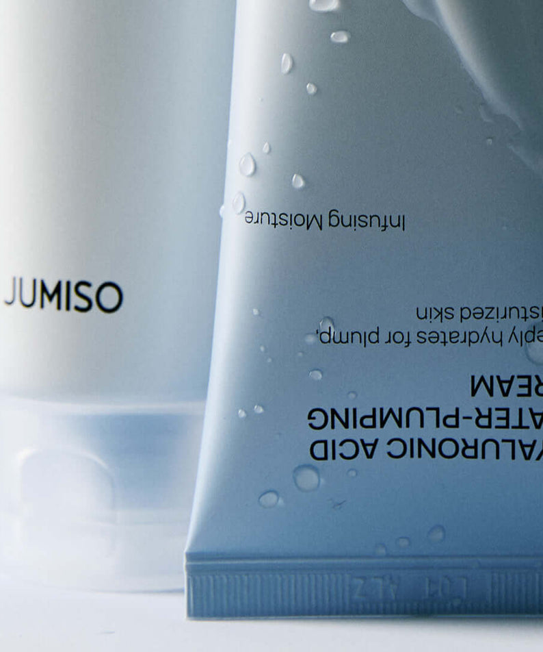 JUMISO Hyaluronic Acid Water Plumping Moisture Cream packaging close-up with water droplets on the tube.