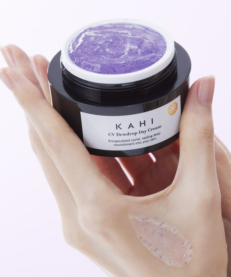 KAHI CV Dewdrop Day Cream 50ml jar held in hand, showing product texture