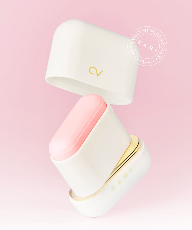 KAHI CV Shine Fit Sun Stick (13.5g) in open case against a pink background, showing the sun stick's packaging and design.