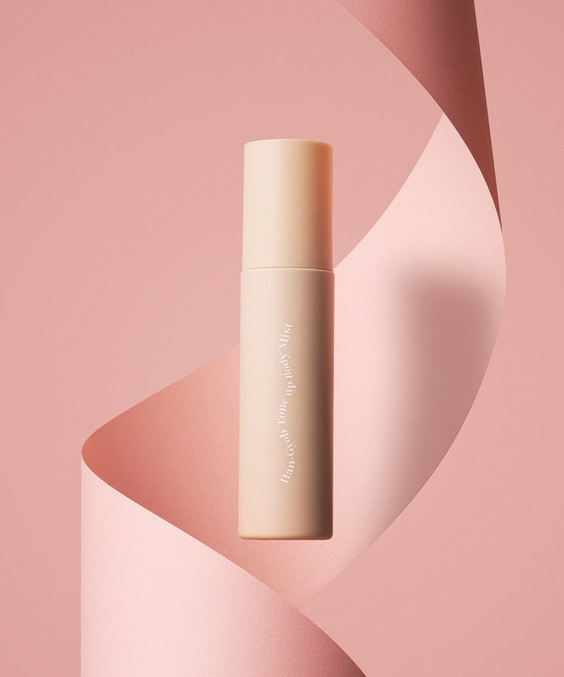 KAHI One Layer Tone-up Body Miist 100ml product bottle on a pink abstract background