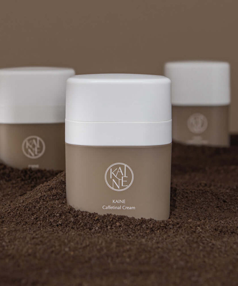 KAINE Caffetinal Cream 50ml jars displayed on a textured surface