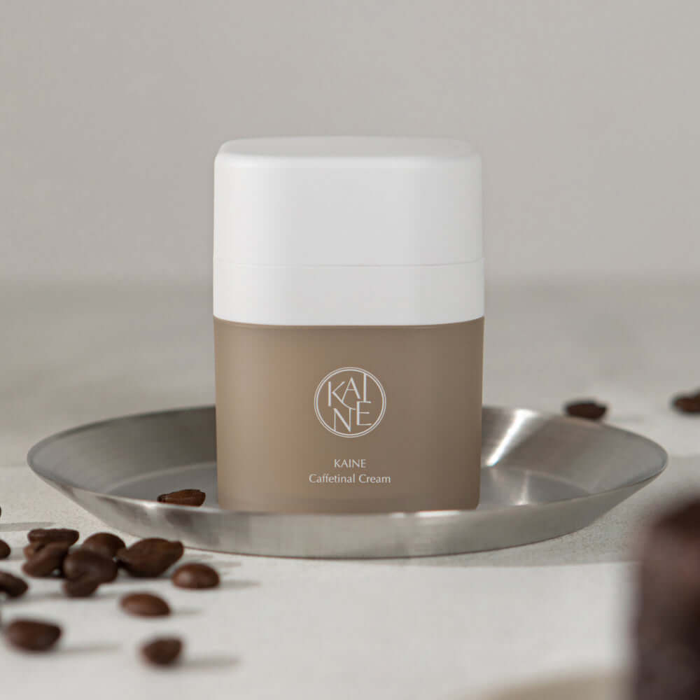 KAINE Caffetinal Cream 50ml on a tray with coffee beans