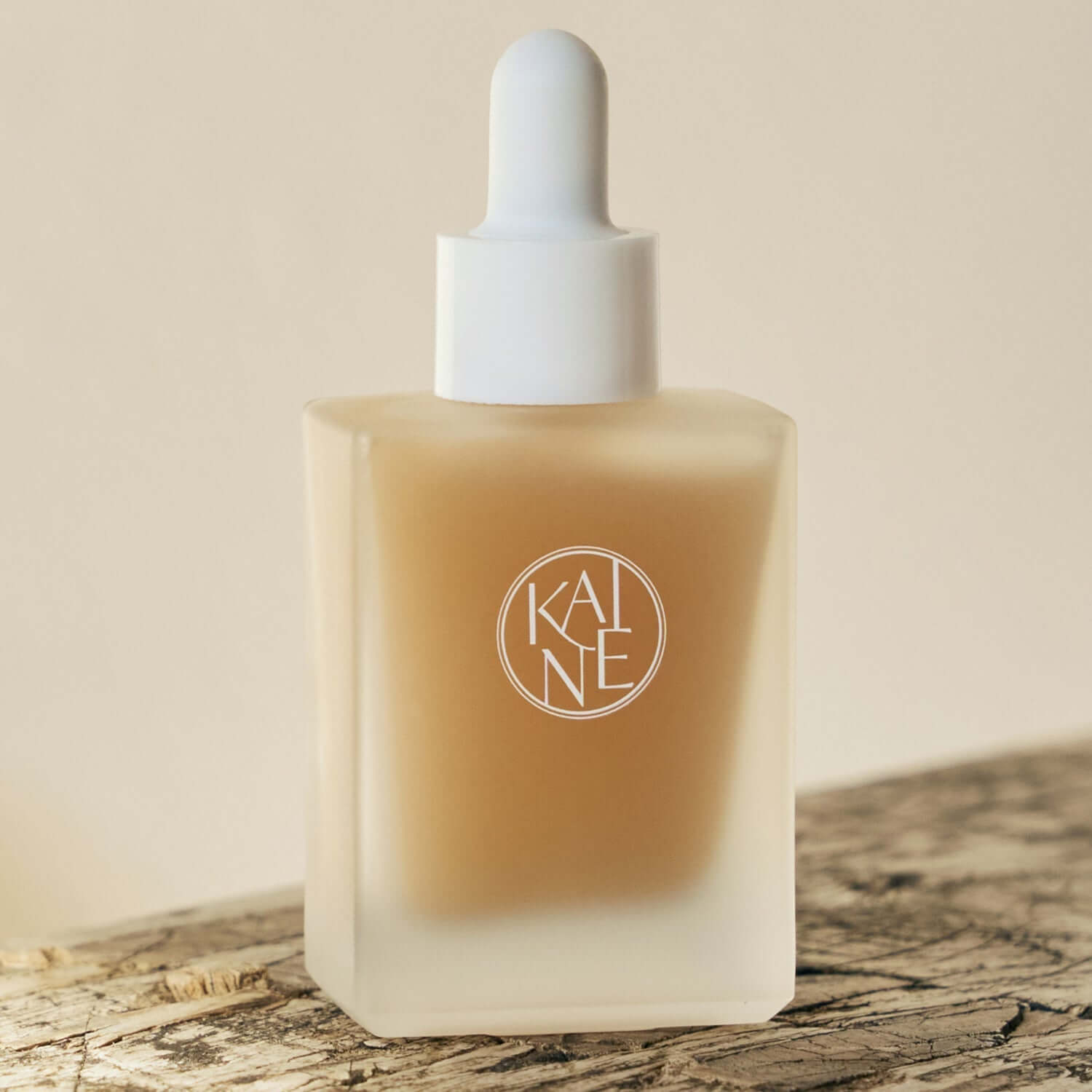 KAINE Kombu Barrier Ampoule in a glass bottle with dropper on a wooden surface