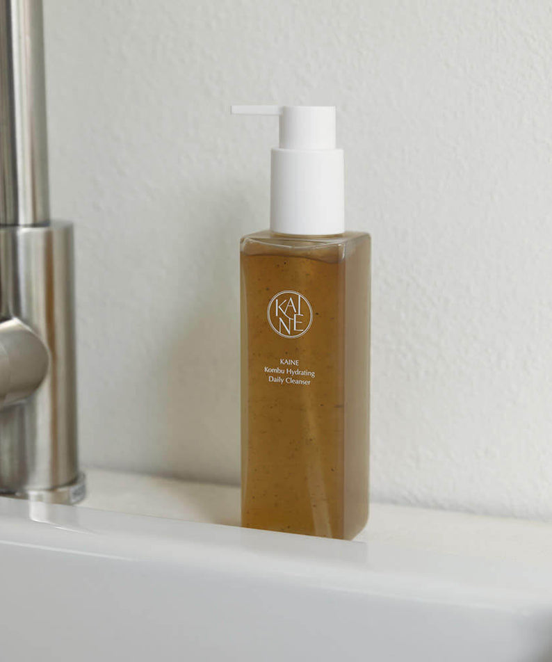 KAINE Kombu Hydrating Daily Cleanser 155g bottle on sink, promoting skincare benefits