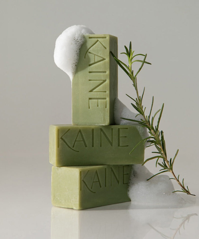 KAINE Rosemary Acne Mildly Acidic Cleansing Bar 100g displayed with soap bubbles and rosemary sprig