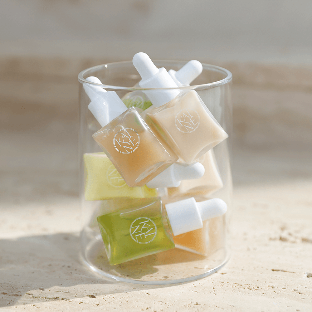 KAINE Serum Discovery Kit featuring various serum bottles in a glass container, perfect for skincare enthusiasts.