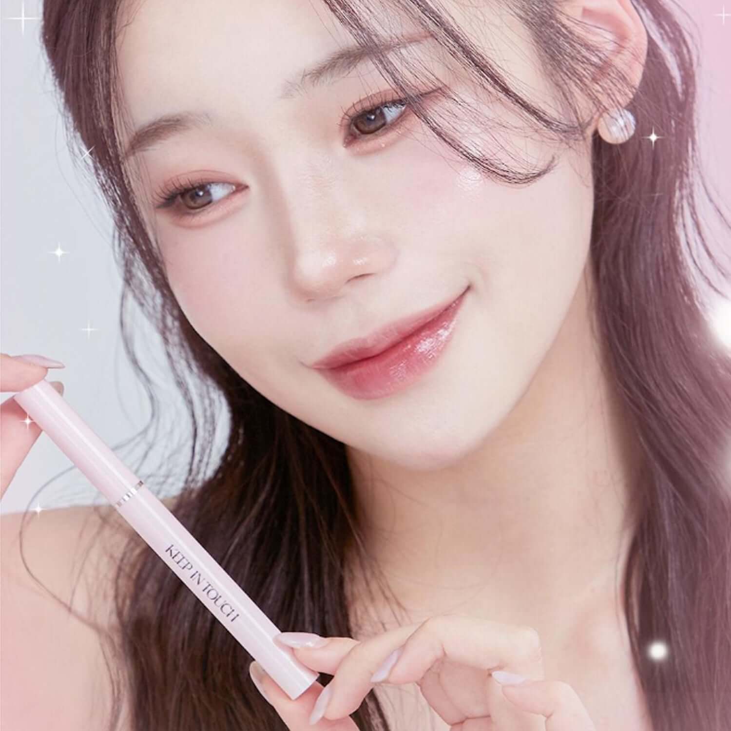 Woman applying KEEP IN TOUCH Glow Lip Sealer Pencil for a glossy finish.