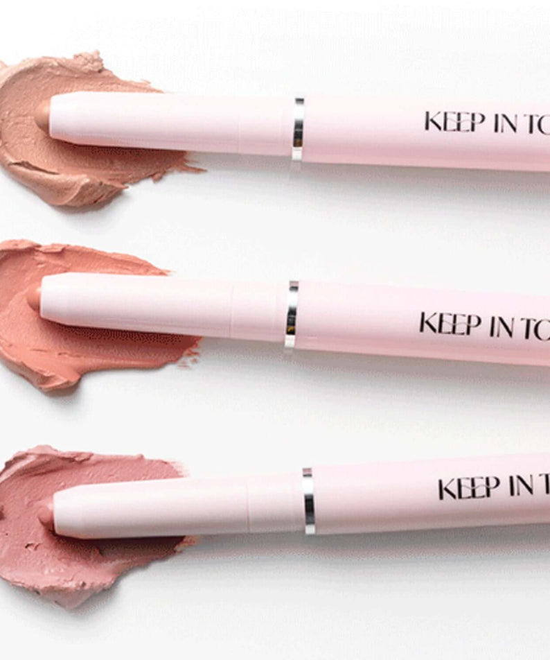 Three KEEP IN TOUCH Glow Lip Sealer Pencils in various shades on white background, showcasing product design and color variety.