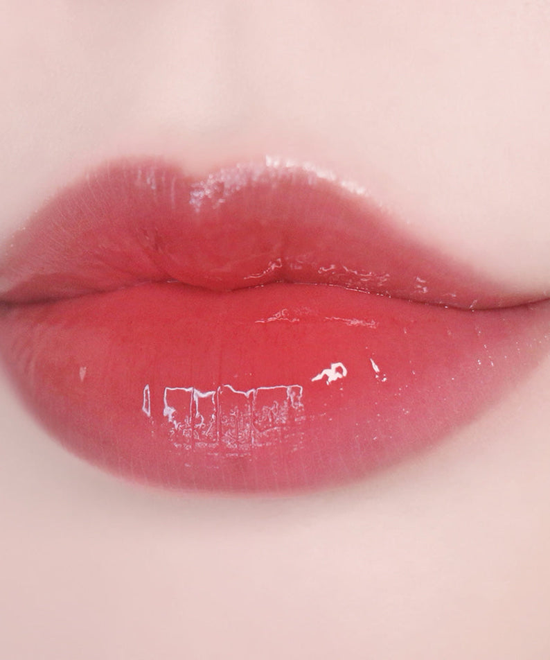 Lips wearing KEEP IN TOUCH Glow Water Lip Tint in a glossy finish.