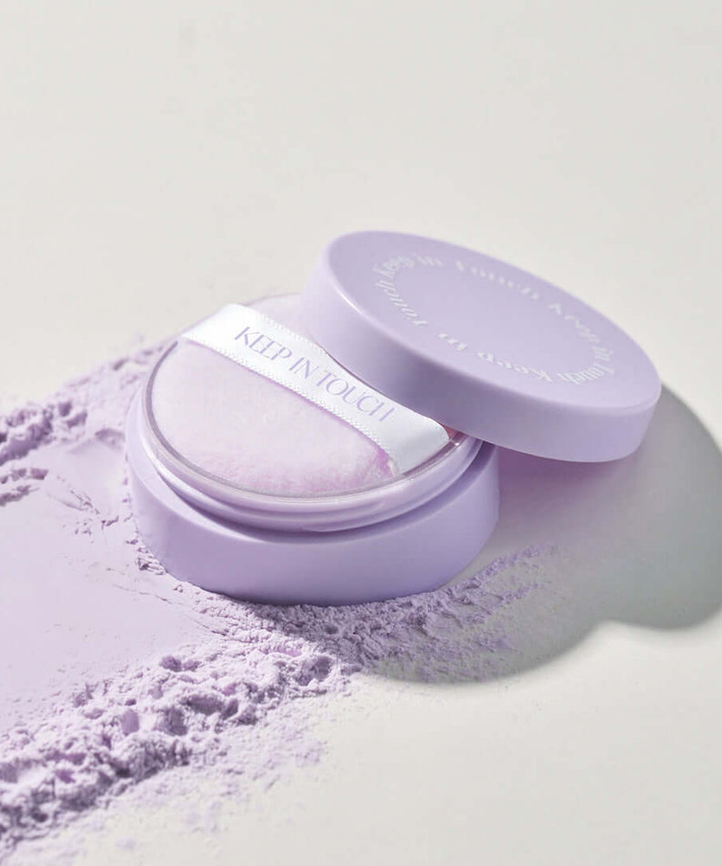 KEEP IN TOUCH Mini Pore Eraser Powder in lavender packaging with open cap and visible powder puff.